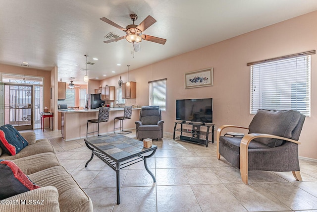 living area featuring light tile patterned floors, visible vents, baseboards, ceiling fan, and recessed lighting