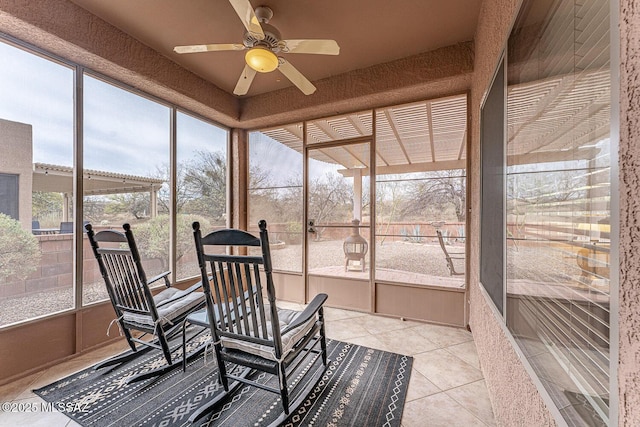 sunroom featuring ceiling fan