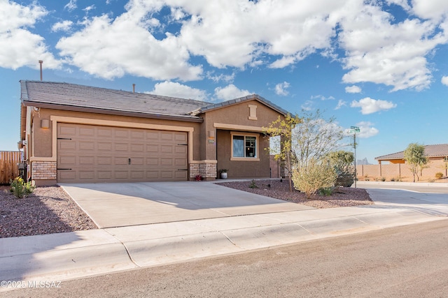 ranch-style home featuring driveway, fence, an attached garage, and stucco siding