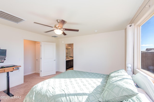 bedroom featuring a ceiling fan, visible vents, light carpet, and baseboards