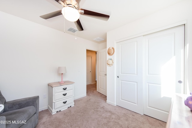 sitting room featuring baseboards, visible vents, and light colored carpet