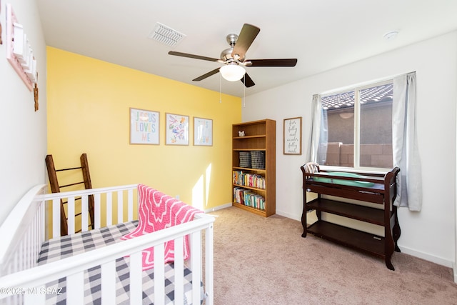 carpeted bedroom with a ceiling fan, visible vents, and baseboards