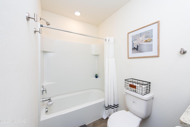 bathroom featuring shower / tub combo and toilet