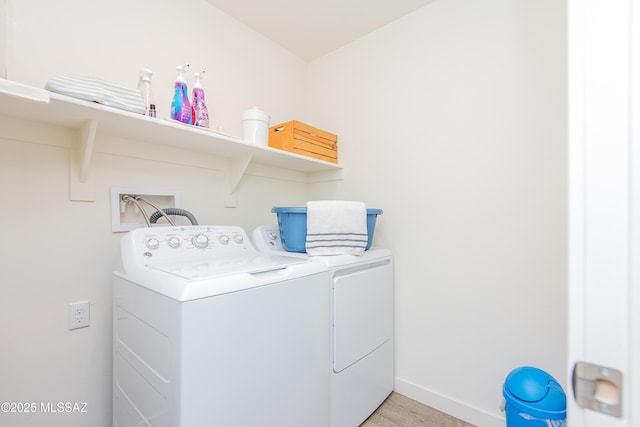 laundry room with light wood-style flooring, laundry area, washer and clothes dryer, and baseboards