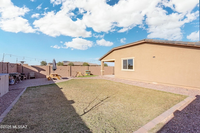 view of yard with a patio and a fenced backyard