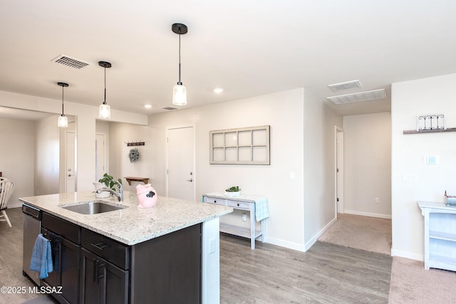 kitchen featuring stainless steel dishwasher, baseboards, visible vents, and a sink