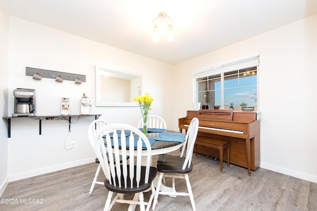 dining room featuring baseboards and wood finished floors