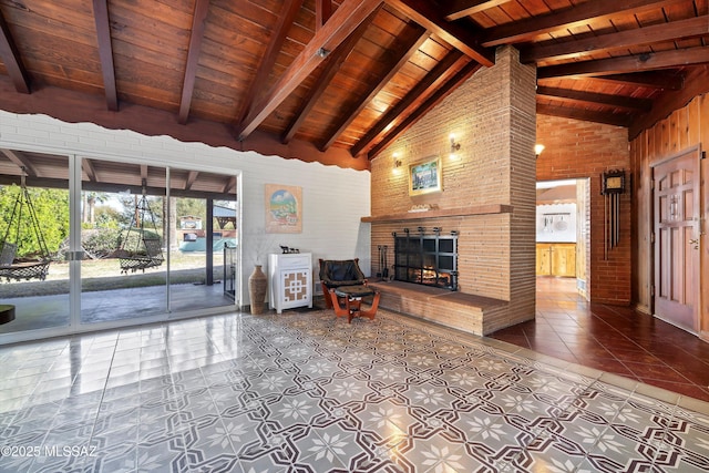 unfurnished living room featuring beamed ceiling, high vaulted ceiling, wooden ceiling, tile patterned flooring, and a brick fireplace