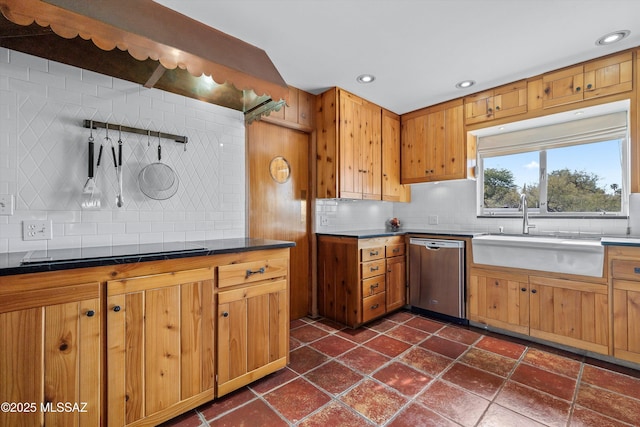 kitchen featuring recessed lighting, a sink, decorative backsplash, dishwasher, and dark countertops