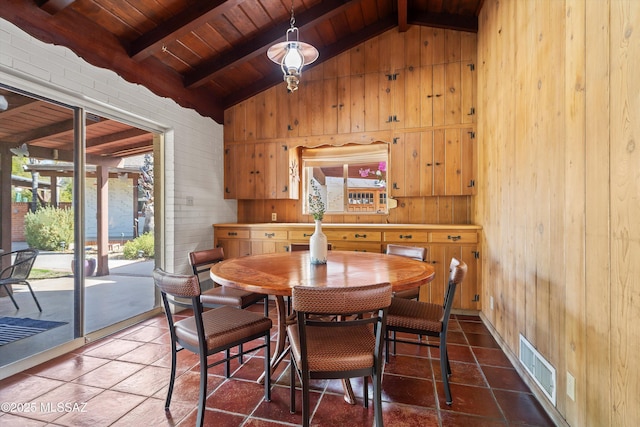 dining area featuring tile patterned flooring, beam ceiling, visible vents, and wooden ceiling