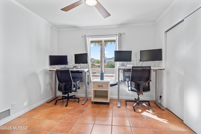 office space featuring a ceiling fan, baseboards, visible vents, light tile patterned flooring, and ornamental molding