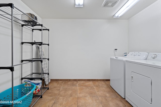 laundry room with washer and dryer, visible vents, baseboards, and laundry area