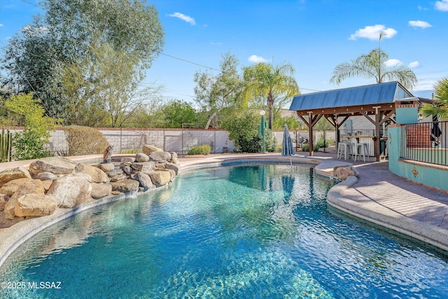 view of pool with a patio, a fenced in pool, a fenced backyard, a gazebo, and outdoor dry bar