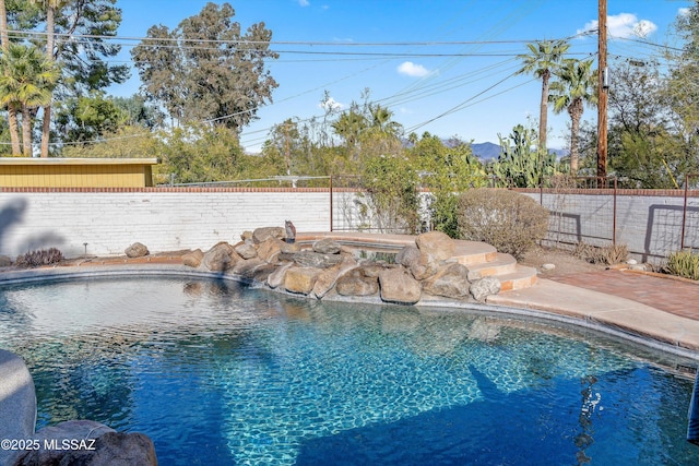 view of pool featuring a jacuzzi, a fenced in pool, and a fenced backyard