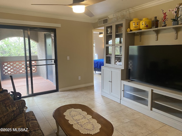 unfurnished living room with visible vents, ornamental molding, a ceiling fan, light tile patterned floors, and baseboards