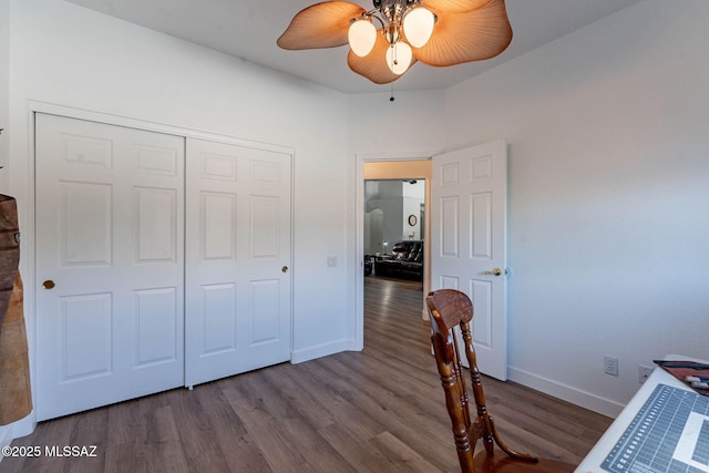 unfurnished bedroom with ceiling fan, a closet, baseboards, and wood finished floors