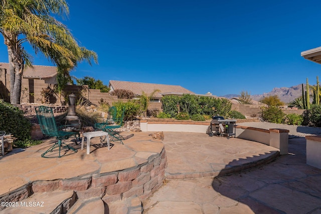 view of patio / terrace featuring a fenced backyard and a mountain view