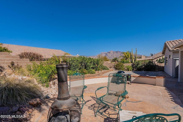 view of patio with a fenced backyard and a mountain view