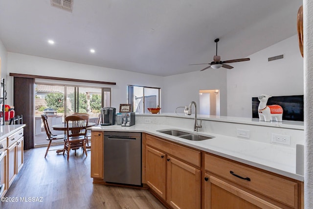 kitchen with a sink, light wood finished floors, visible vents, and stainless steel dishwasher