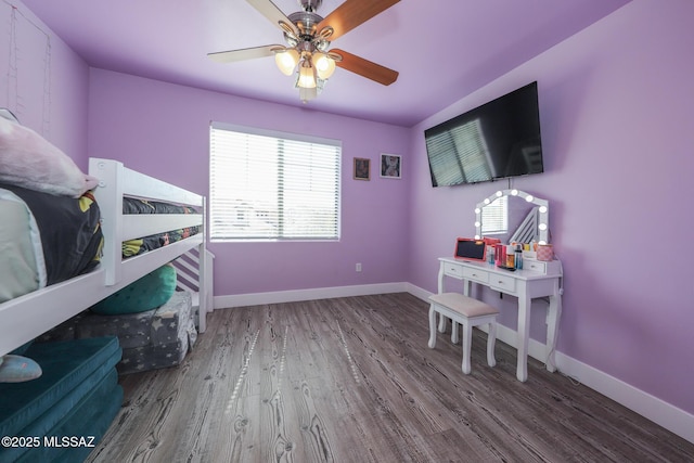 bedroom featuring a ceiling fan, wood finished floors, and baseboards