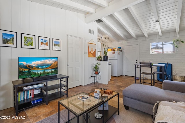 living area featuring vaulted ceiling with beams and visible vents