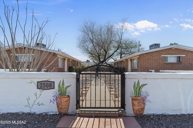 view of gate featuring a fenced front yard