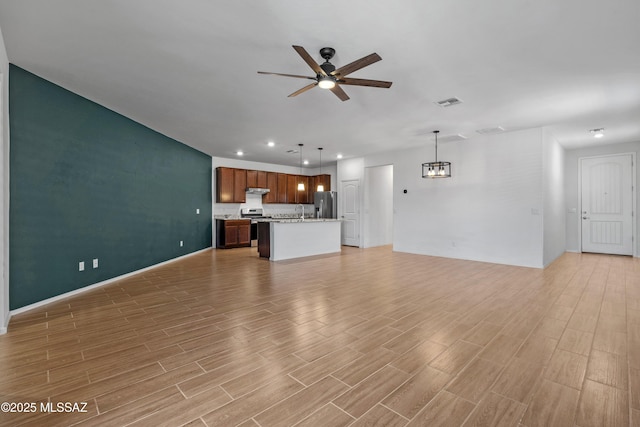 unfurnished living room featuring visible vents, a ceiling fan, a sink, recessed lighting, and light wood finished floors