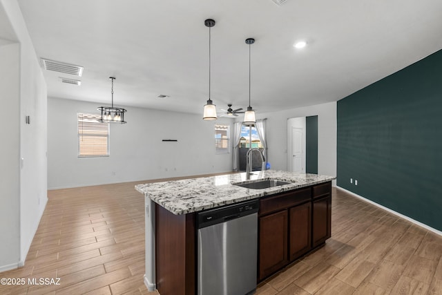 kitchen featuring wood finish floors, visible vents, a sink, plenty of natural light, and stainless steel dishwasher