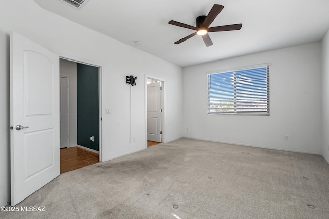 unfurnished bedroom featuring visible vents, baseboards, ceiling fan, and carpet flooring