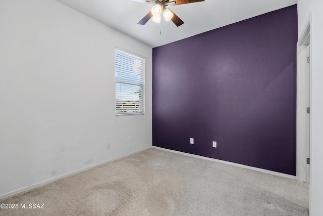 unfurnished room featuring carpet flooring, a ceiling fan, and baseboards