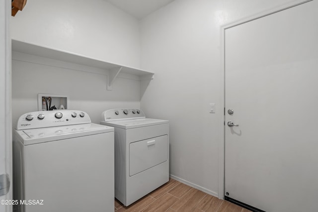 washroom with laundry area, independent washer and dryer, and wood finish floors