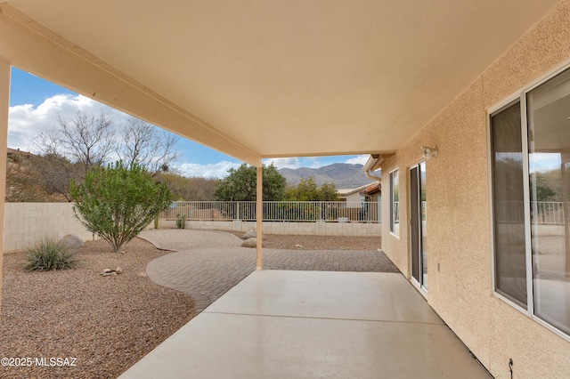 63606 E Desert Peak Dr, Tucson, AZ 85739 - view of patio / terrace featuring a fenced backyard and a mountain view