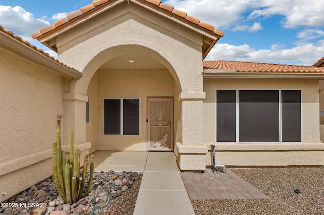 63606 E Desert Peak Dr, Tucson, AZ 85739 - entrance to property featuring a tile roof, a patio area, and stucco siding