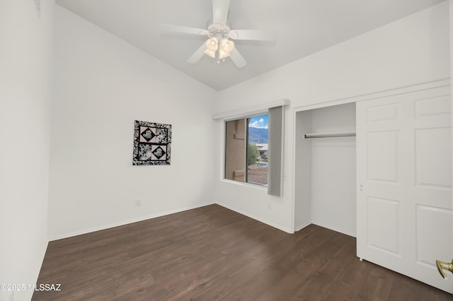 63606 E Desert Peak Dr, Tucson, AZ 85739 - unfurnished bedroom featuring lofted ceiling, baseboards, dark wood-style flooring, and a closet
