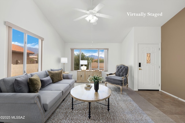 tiled living area with vaulted ceiling, a ceiling fan, and baseboards