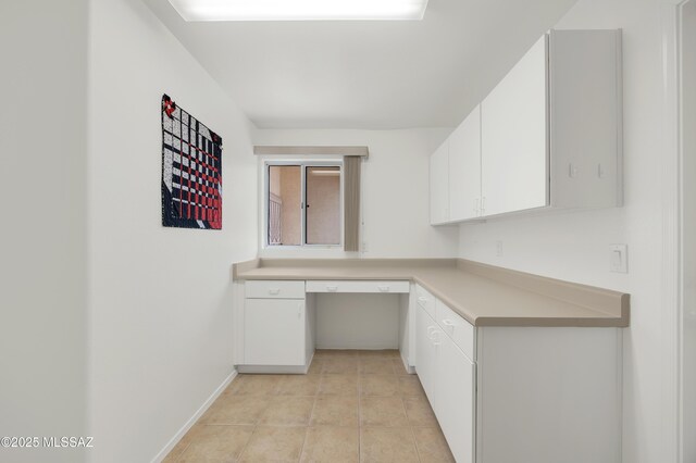 63606 E Desert Peak Dr, Tucson, AZ 85739 - unfurnished office featuring light tile patterned floors, built in study area, and baseboards