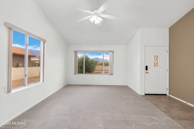 63606 E Desert Peak Dr, Tucson, AZ 85739 - carpeted empty room with baseboards, tile patterned flooring, a ceiling fan, and lofted ceiling