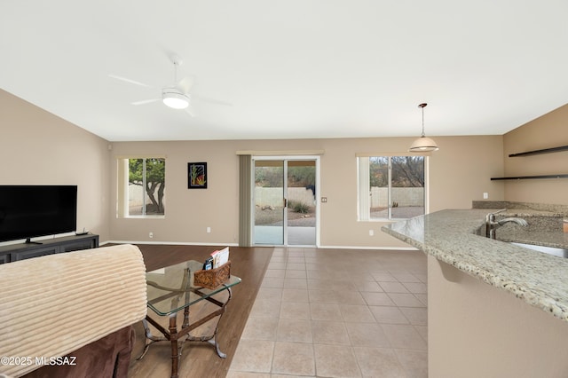 63606 E Desert Peak Dr, Tucson, AZ 85739 - living room with lofted ceiling, light tile patterned floors, baseboards, and plenty of natural light