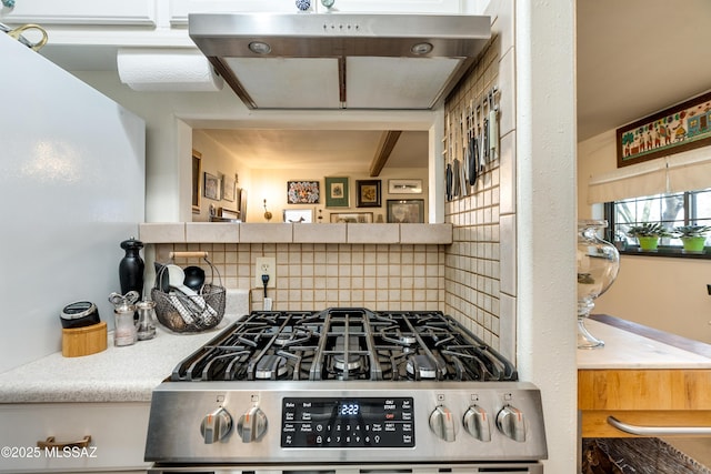 kitchen featuring backsplash and gas range