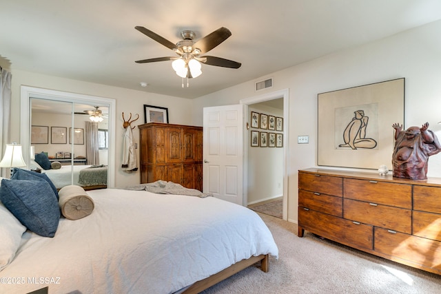 bedroom featuring visible vents, baseboards, light colored carpet, a closet, and a ceiling fan