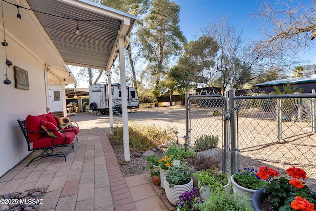 view of patio featuring fence and a gate