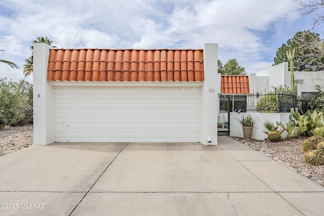 detached garage featuring fence