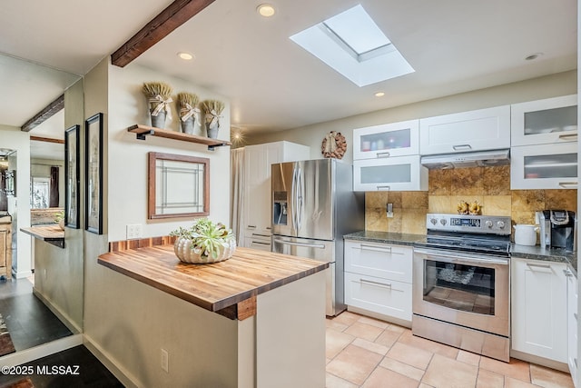 kitchen featuring backsplash, appliances with stainless steel finishes, glass insert cabinets, white cabinets, and under cabinet range hood