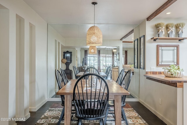 dining room with beam ceiling and baseboards