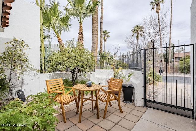 view of patio / terrace featuring fence and a gate