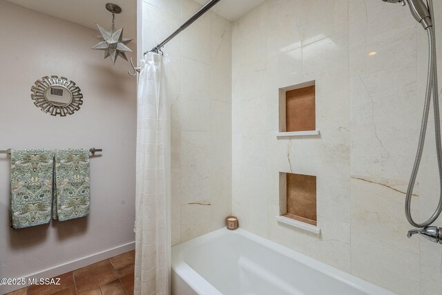 full bathroom with baseboards and shower / bath combo with shower curtain