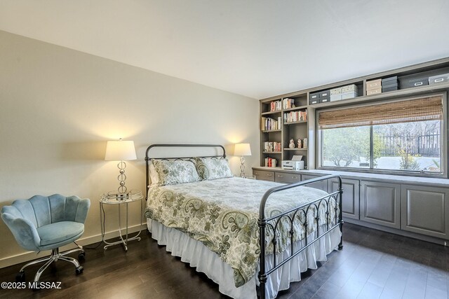 bedroom featuring baseboards and dark wood-type flooring