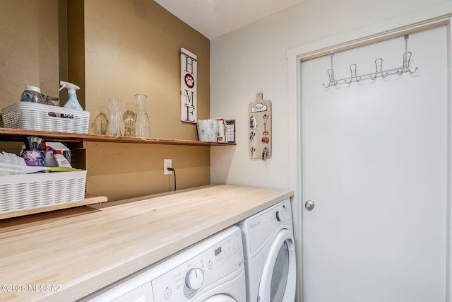 clothes washing area featuring washer and dryer and laundry area