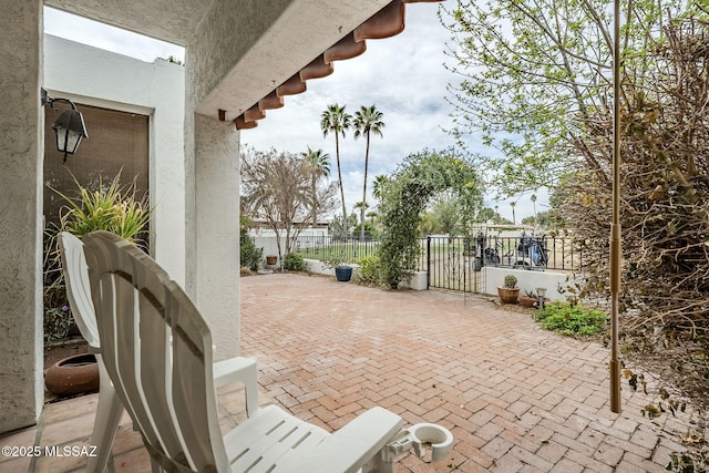 view of patio featuring fence