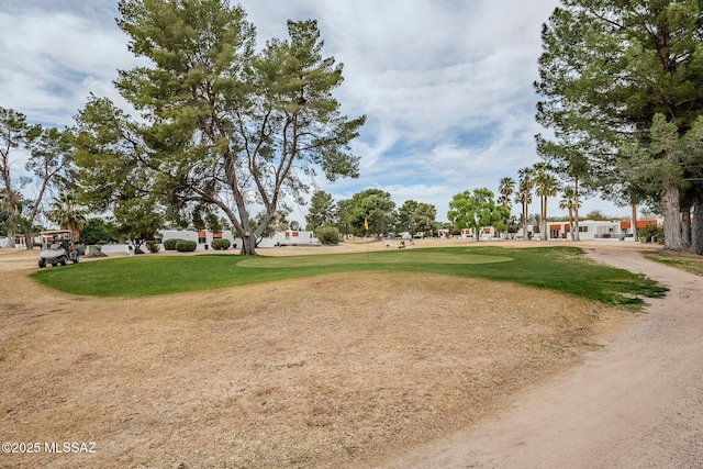 view of home's community with a yard and golf course view